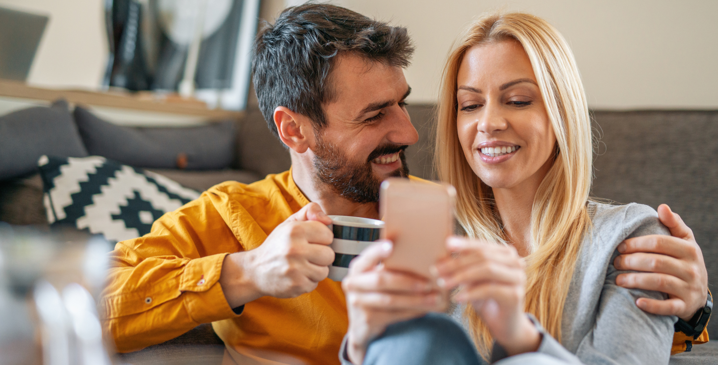 Couple snuggling with phone